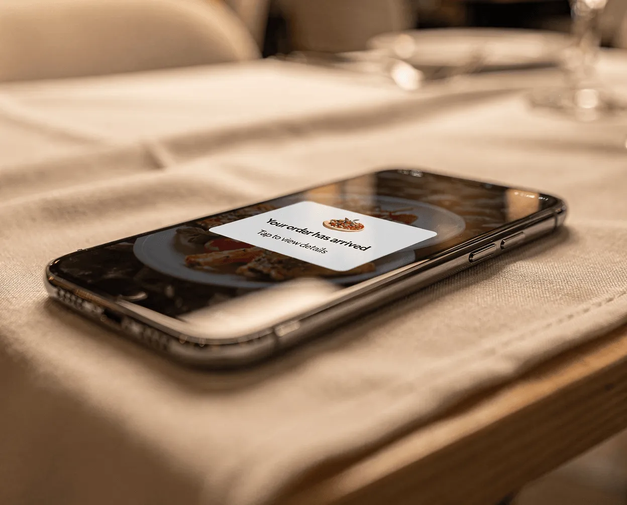 Mobile phone showing push notification from WooCommerce food app offering personalized food discount